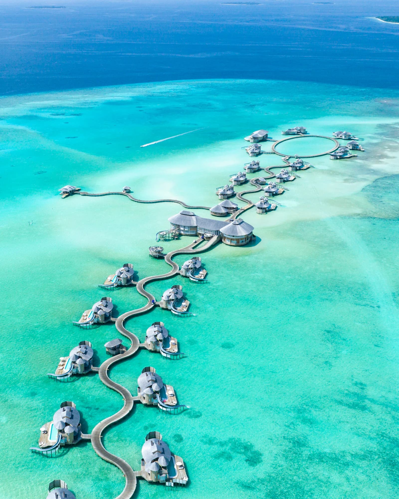 Overwater villas above turquoise water in the Maldives